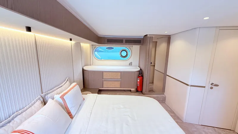  Yacht Photos Pics Luxurious bedroom interior of 2025 Azimut Magellano 60 yacht with modern design and porthole view.