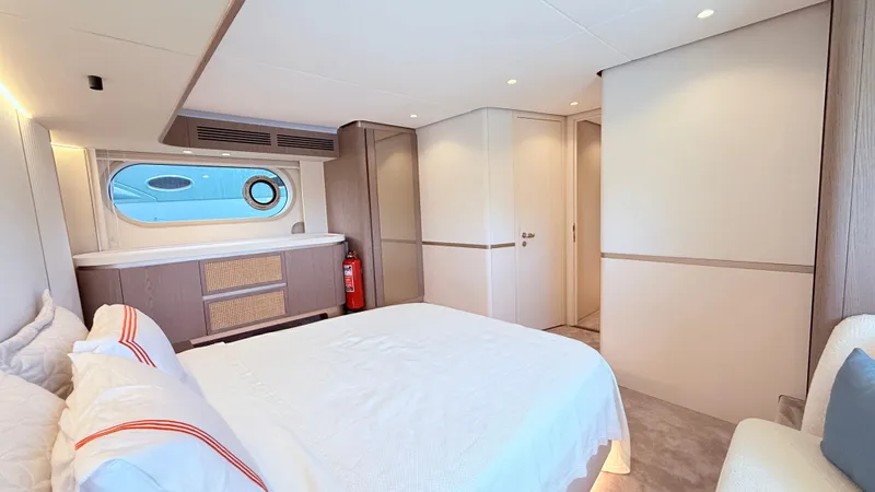  Yacht Photos Pics Luxurious bedroom interior of 2025 Azimut Magellano 60 yacht, featuring modern design and elegant furnishings.