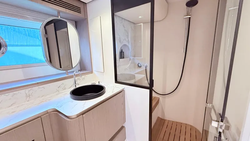  Yacht Photos Pics Luxurious bathroom interior of 2025 Azimut Magellano 60 yacht with modern fixtures.