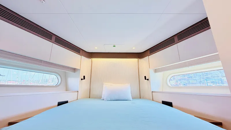  Yacht Photos Pics Luxurious bedroom interior of 2025 Azimut Magellano 60 yacht with modern design.