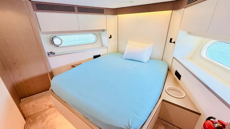  Yacht Photos Pics Luxurious bedroom interior of 2025 Azimut Magellano 60 yacht with ocean view.