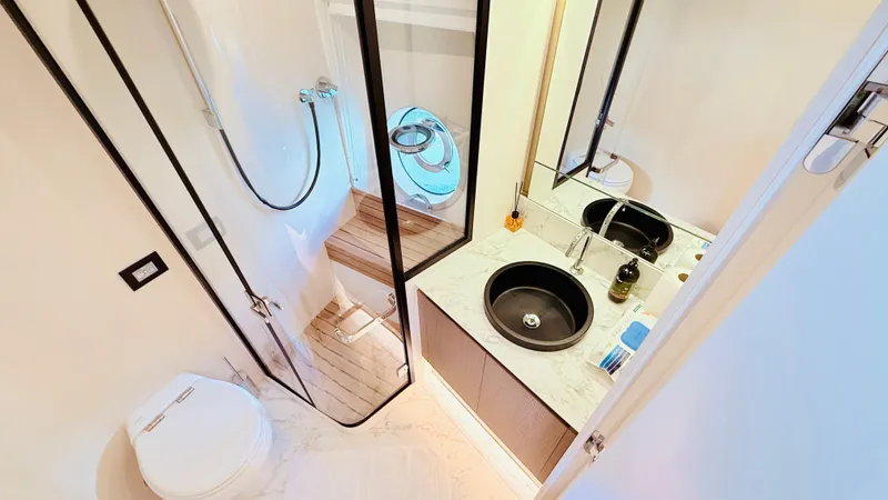  Yacht Photos Pics Luxurious bathroom in 2025 Azimut Magellano 60 yacht, featuring modern fixtures and elegant design.