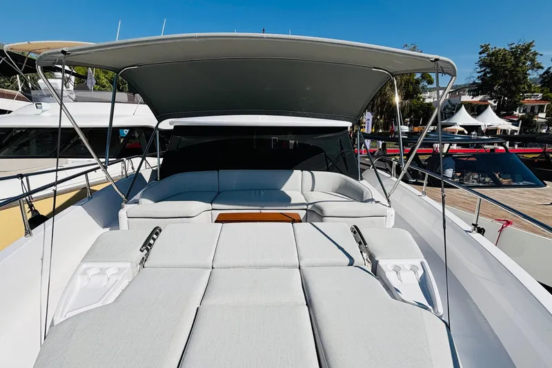  Yacht Photos Pics 2025 Azimut Magellano 60 yacht with sunshade and luxurious seating area.
