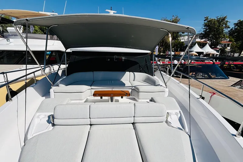  Yacht Photos Pics Luxurious 2025 Azimut Magellano 60 yacht with spacious sun deck and elegant seating area.