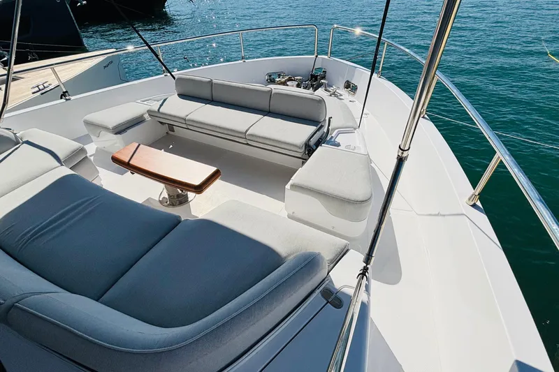  Yacht Photos Pics Luxurious seating area on 2025 Azimut Magellano 60 yacht, overlooking serene blue waters.