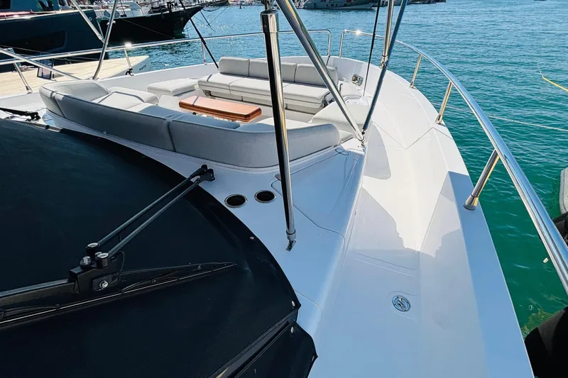  Yacht Photos Pics 2025 Azimut Magellano 60 yacht deck with seating area, docked in marina.