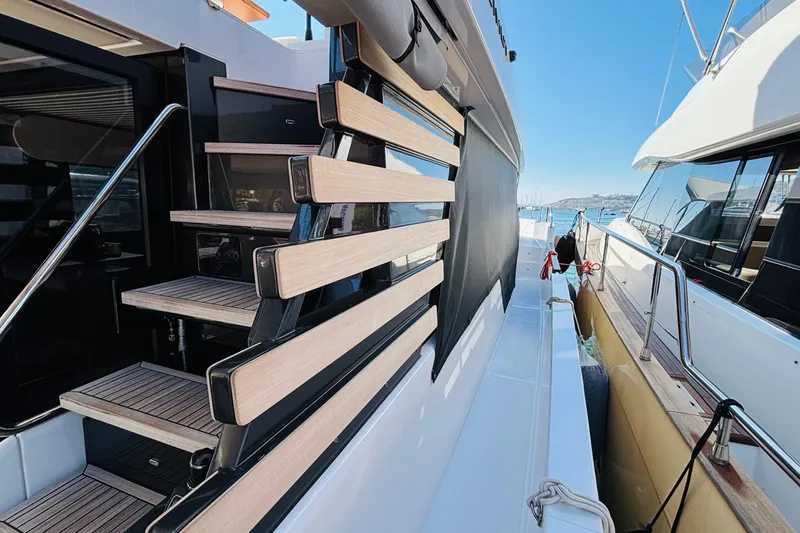  Yacht Photos Pics 2025 Azimut Magellano 60 yacht with modern staircase and sleek design.