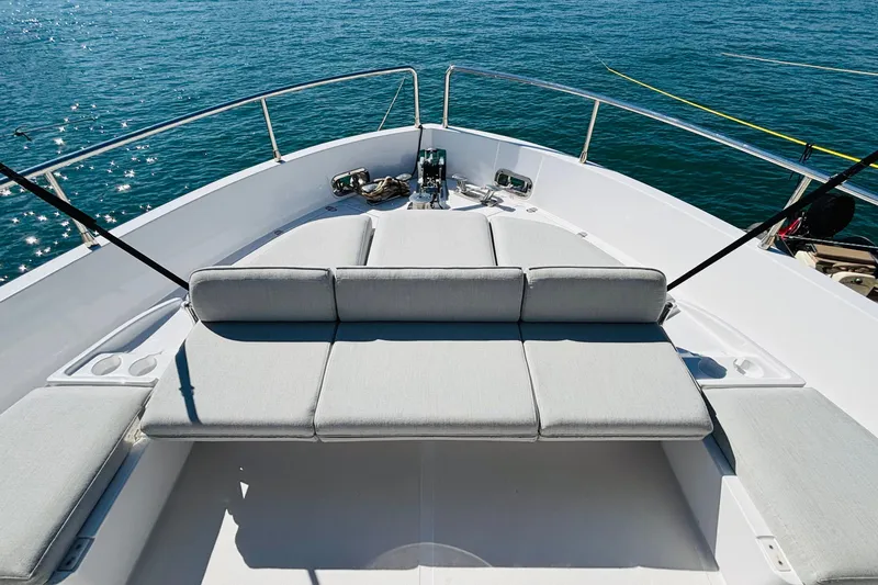  Yacht Photos Pics Luxurious deck of 2025 Azimut Magellano 60 yacht with cushioned seating.