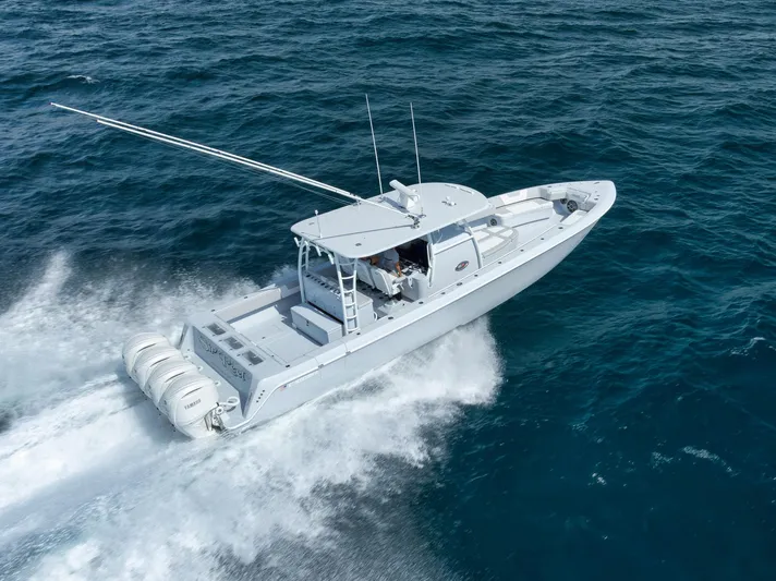 O'fishal Business Yacht Photos Pics 2025 Contender 44 ST boat cruising on open ocean waters.