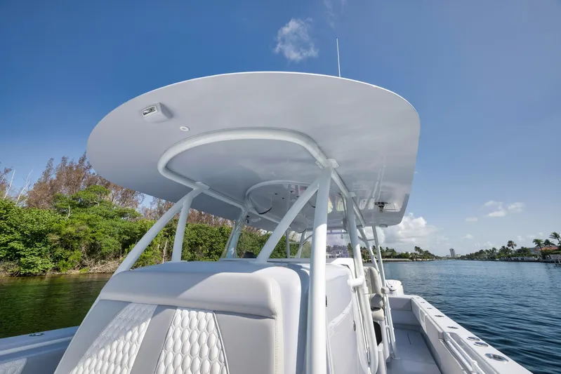 O'fishal Business Yacht Photos Pics 2025 Contender 44 ST boat on calm water, featuring sleek design and modern canopy.