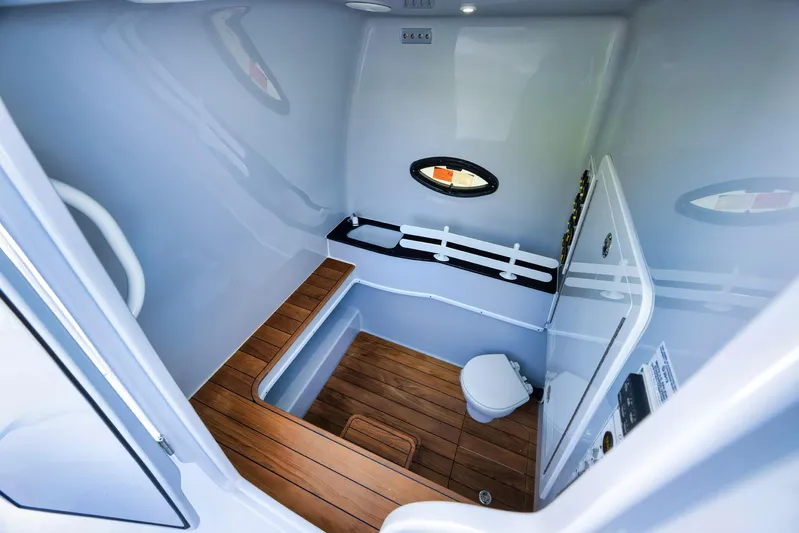 O'fishal Business Yacht Photos Pics 2025 Contender 44 ST boat interior with wooden flooring and compact bathroom amenities.