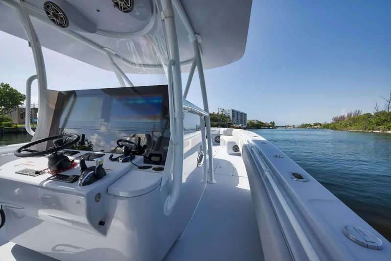 O'fishal Business Yacht Photos Pics 2025 Contender 44 ST boat on a sunny day, featuring a sleek helm and open water view.