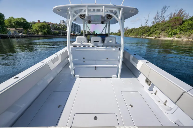 O'fishal Business Yacht Photos Pics 2025 Contender 44 ST boat interior, spacious deck, sleek design, calm water backdrop.