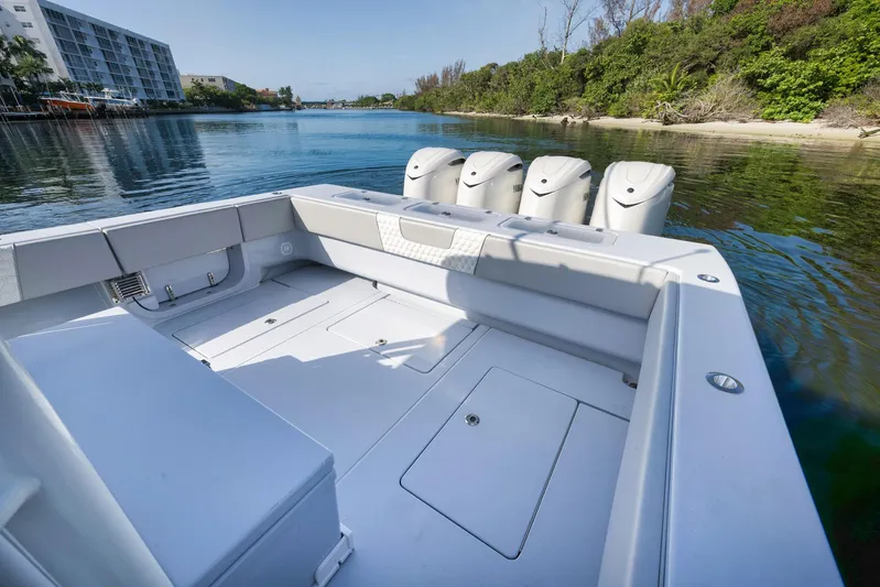 O'fishal Business Yacht Photos Pics 2025 Contender 44 ST boat with multiple engines, docked in a scenic waterway.