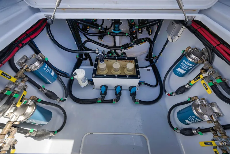 O'fishal Business Yacht Photos Pics Engine compartment of 2025 Contender 44 ST boat, showcasing fuel filters and hoses.