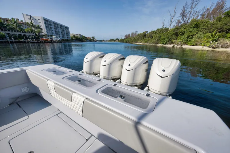 O'fishal Business Yacht Photos Pics 2025 Contender 44 ST boat with powerful outboard engines on a serene waterway.