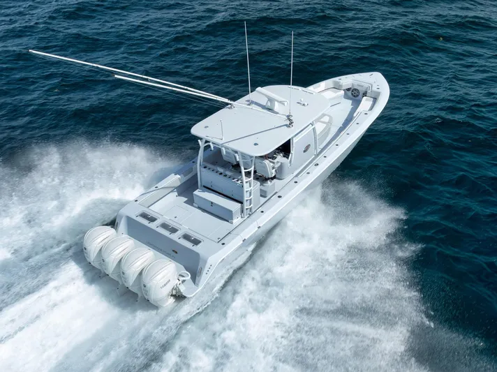 O'fishal Business Yacht Photos Pics 2025 Contender 44 ST boat cruising on open ocean waters.