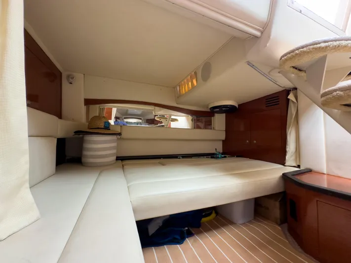  Yacht Photos Pics Interior cabin of 2005 Sea Ray 340 Sundancer with beige seating and wooden accents.