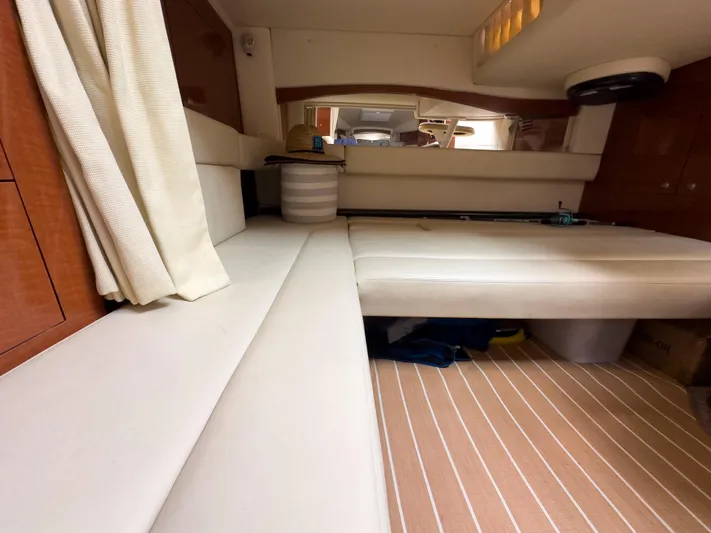  Yacht Photos Pics Interior cabin of 2005 Sea Ray 340 Sundancer with beige seating and striped flooring.