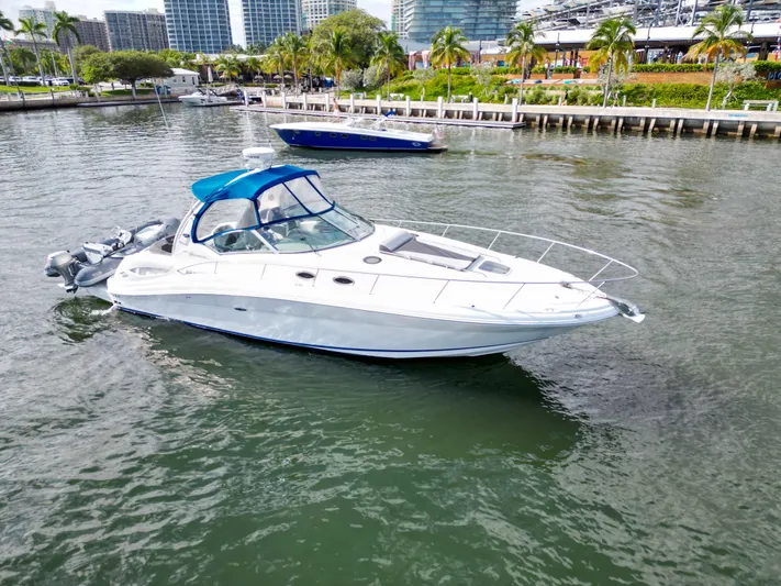  Yacht Photos Pics 2005 Sea Ray 340 Sundancer yacht docked in a scenic marina.