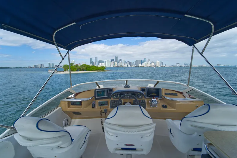 Yacht Photos Pics 2002 Carver 410 Sport Sedan yacht cockpit with city skyline view.