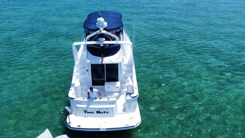  Yacht Photos Pics 2002 Carver 410 Sport Sedan on clear turquoise water, aerial view.