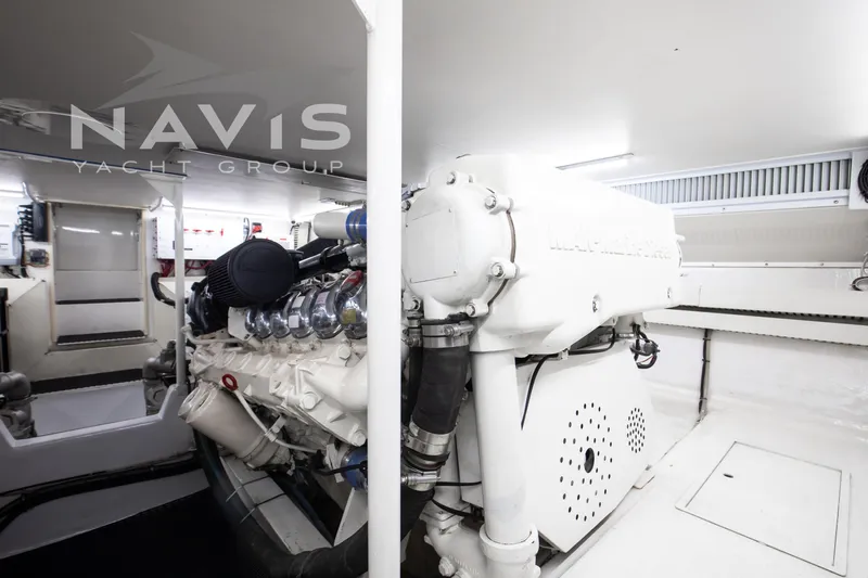 Covert Mission Yacht Photos Pics Engine room of 1998 Viking 58 Convertible yacht, featuring advanced machinery and clean design.