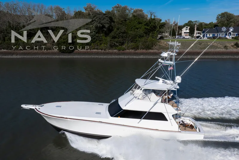 Covert Mission Yacht Photos Pics 1998 Viking 58 Convertible yacht cruising on a river, Navis Yacht Group logo visible.