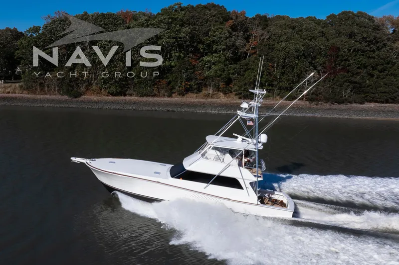 Covert Mission Yacht Photos Pics 1998 Viking 58 Convertible yacht cruising on a river, Navis Yacht Group logo visible.