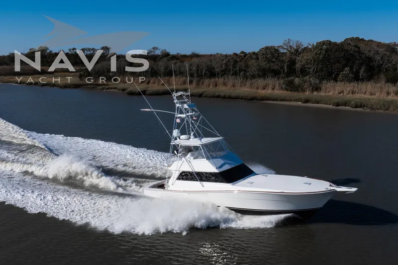 Covert Mission Yacht Photos Pics 1998 Viking 58 Convertible yacht cruising on a river, Navis Yacht Group logo visible.