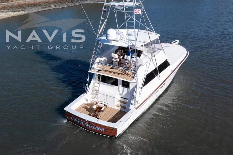 Covert Mission Yacht Photos Pics 1998 Viking 58 Convertible yacht cruising on calm waters, Navis Yacht Group branding visible.
