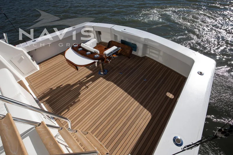 Covert Mission Yacht Photos Pics 1998 Viking 58 Convertible yacht deck with wooden flooring and fishing chair.