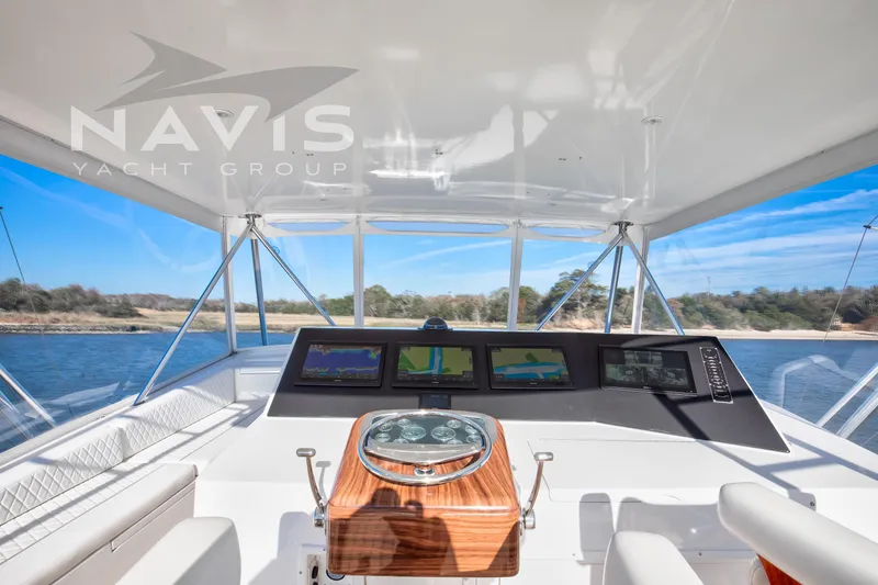 Covert Mission Yacht Photos Pics Cockpit view of 1998 Viking 58 Convertible yacht with navigation screens and steering wheel.