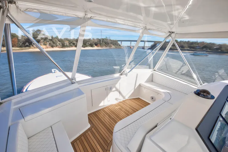 Covert Mission Yacht Photos Pics Interior view of 1998 Viking 58 Convertible yacht with scenic waterway backdrop.