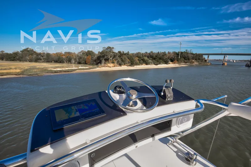 Covert Mission Yacht Photos Pics 1998 Viking 58 Convertible yacht helm with scenic river view.