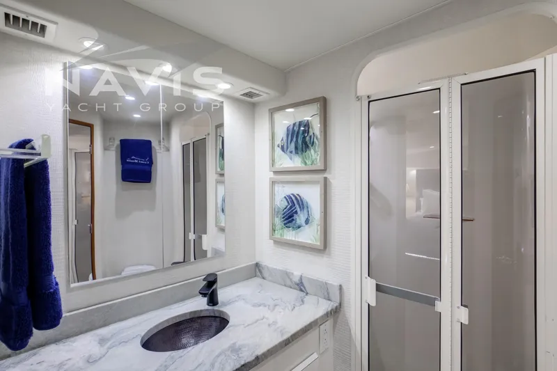 Covert Mission Yacht Photos Pics Luxurious master bathroom with solid surface countertop and modern fixtures.