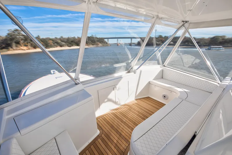 Covert Mission Yacht Photos Pics Interior view of 1998 Viking 58 Convertible yacht with elegant seating and scenic waterway.