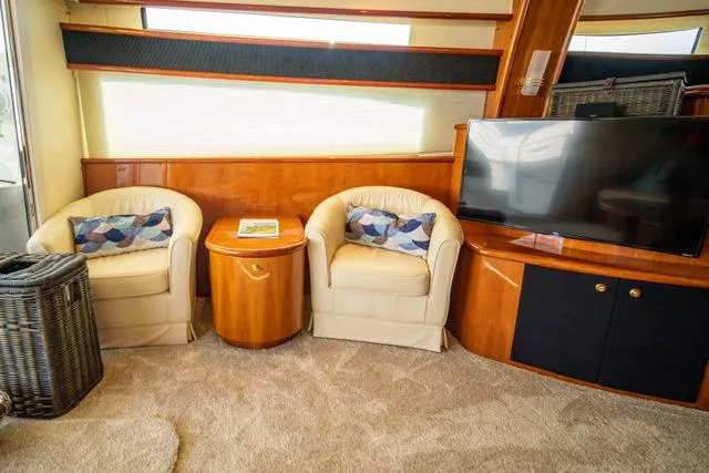  Yacht Photos Pics Luxurious Neptunus 62 Flybridge 2005 interior with cozy seating and modern TV setup.