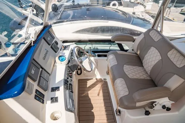  Yacht Photos Pics 2005 Neptunus 62 Flybridge helm with luxurious seating and advanced navigation controls.