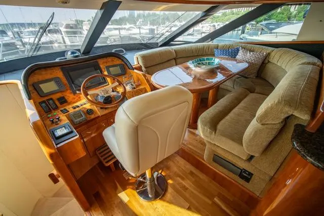  Yacht Photos Pics Luxurious 2005 Neptunus 62 Flybridge yacht interior with plush seating and modern helm.