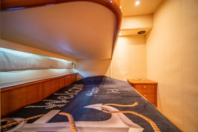  Yacht Photos Pics Luxurious 2005 Neptunus 62 Flybridge yacht cabin with nautical-themed bedding.