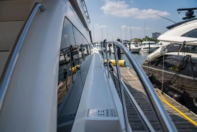  Yacht Photos Pics Side view of 2005 Neptunus 62 Flybridge yacht docked at marina.