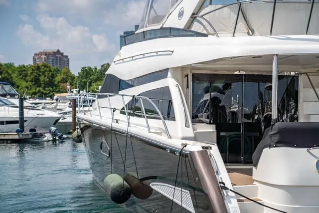  Yacht Photos Pics 2005 Neptunus 62 Flybridge yacht docked in marina, sunny day.