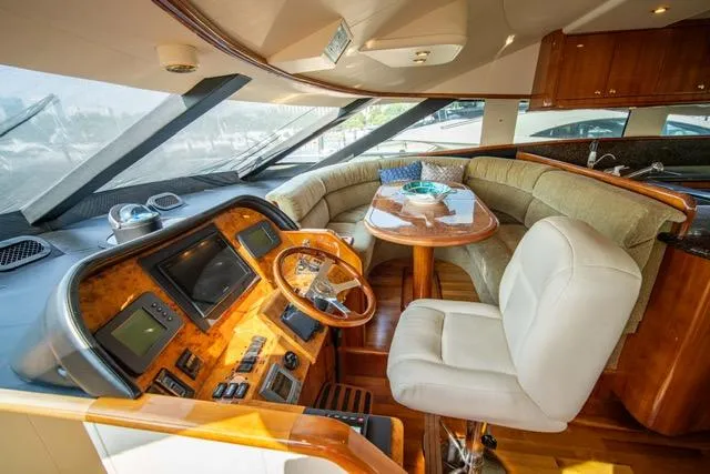  Yacht Photos Pics Luxurious 2005 Neptunus 62 Flybridge yacht interior with helm and plush seating area.