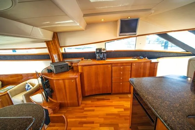  Yacht Photos Pics Luxurious interior of 2005 Neptunus 62 Flybridge yacht with wood cabinetry and modern amenities.