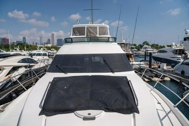  Yacht Photos Pics 2005 Neptunus 62 Flybridge yacht docked in marina under clear blue sky.