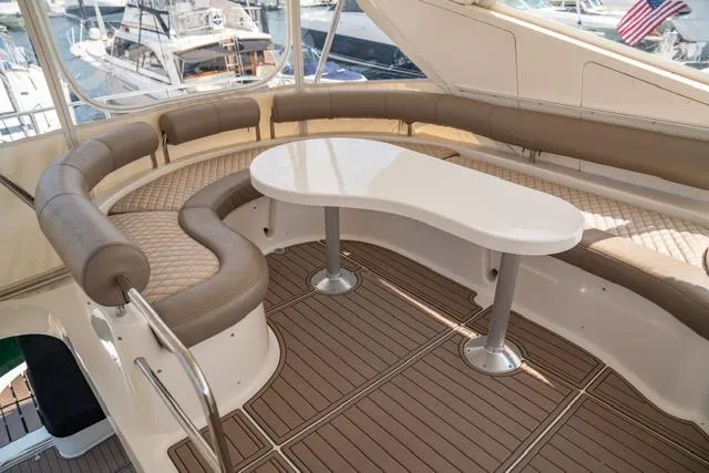  Yacht Photos Pics Luxurious 2005 Neptunus 62 Flybridge yacht with elegant seating and sleek table design.