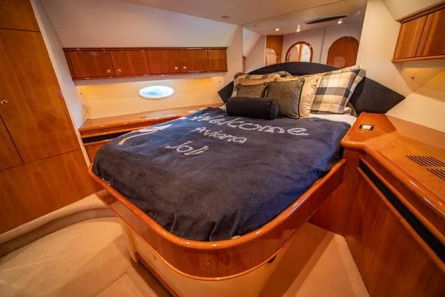  Yacht Photos Pics Luxurious bedroom in 2005 Neptunus 62 Flybridge yacht with elegant wood finishes.