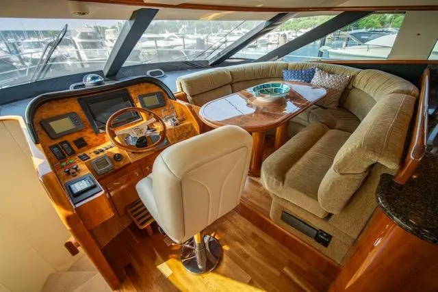  Yacht Photos Pics Luxurious 2005 Neptunus 62 Flybridge yacht interior with plush seating and elegant helm.