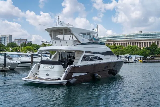  Yacht Photos Pics 2005 Neptunus 62 Flybridge yacht docked in marina, clear sky, cityscape background.